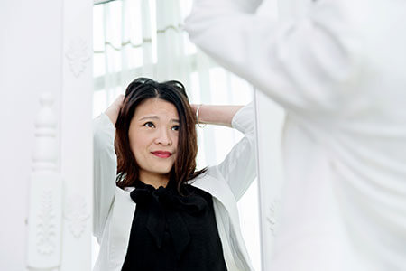 A woman with hair loss or thinning hair should try to pinpoint the cause. a woman with hair loss or thinning hair should try to pinpoint the cause