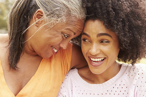 Many of us find joy from our family and friends. closeup of mother and daughter laughing together