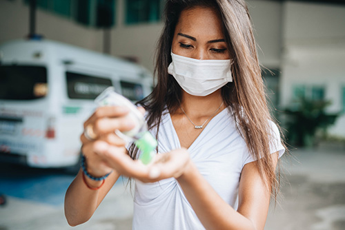 Woman applying hand sanitizer