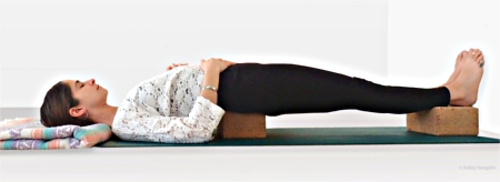 Supported Bridge Pose using two yoga blocks and one blanket Supported Bridge Pose using two yoga blocks and one blanket