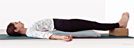 Supported Bridge Pose using a yoga block and blanket Supported Bridge Pose using a yoga block and blanket