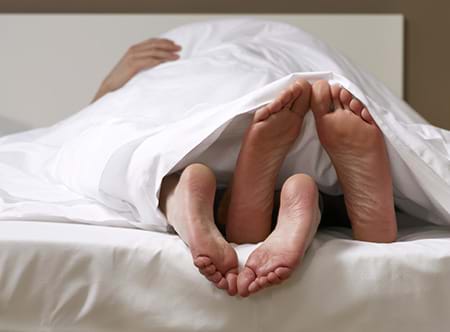 A lovemaking couple in bed enjoying themselves lovemaking couple in bed enjoying themselves