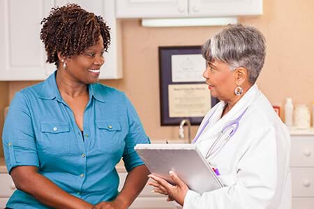 A woman can reduce her risk for heart disease by working with her doctor. a woman can reduce her risk for heart disease by working with her doctor