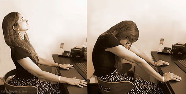 Woman doing Cat Cow yoga pose at desk Woman doing Cat Cow yoga pose