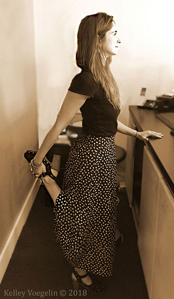Woman doing Dancer yoga pose at her desk Woman doing Dancer yoga pose
